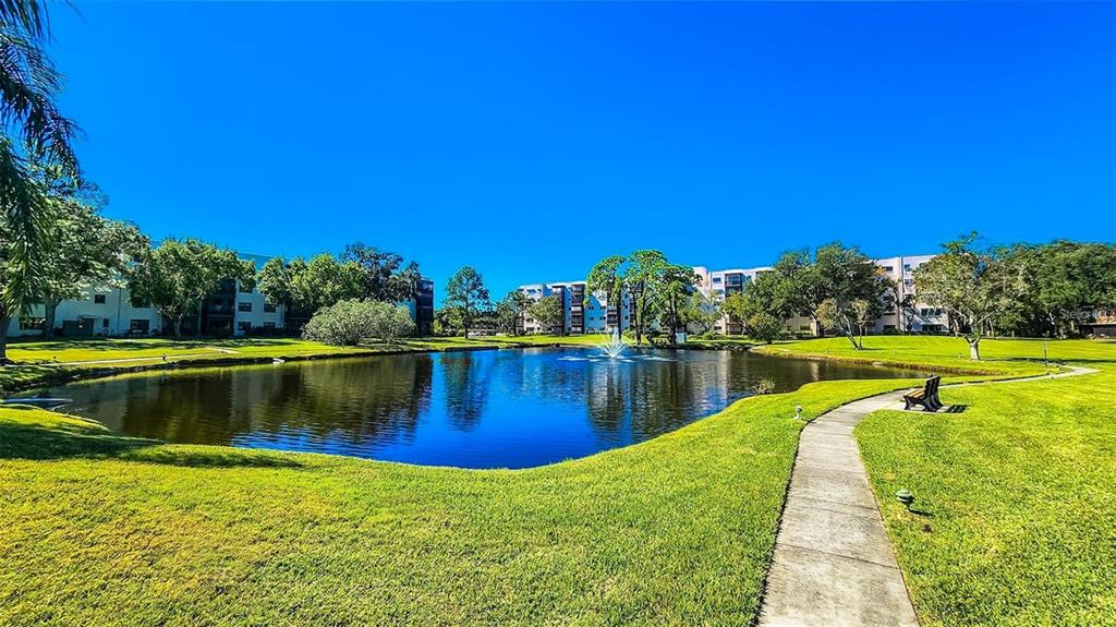 5660 80th Street North, Unit A303 St. Petersburg, FL 33709 - Photo 36 of 72 a view of a lake with a house in the background