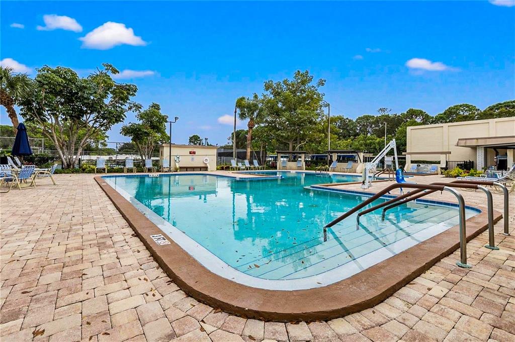 5660 80th Street North, Unit A303 St. Petersburg, FL 33709 - Photo 38 of 72 a view of a swimming pool with a patio
