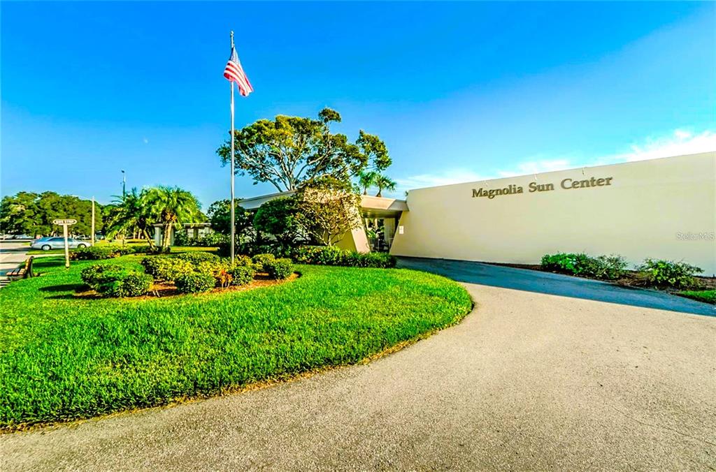 5660 80th Street North, Unit A303 St. Petersburg, FL 33709 - Photo 43 of 72 a view of a garden with a building in the background