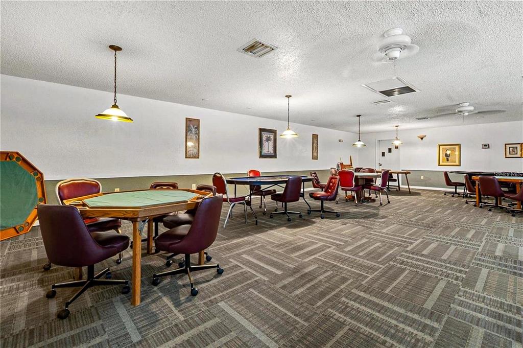 5660 80th Street North, Unit A303 St. Petersburg, FL 33709 - Photo 46 of 72 a living room with lots of furniture and a chandelier