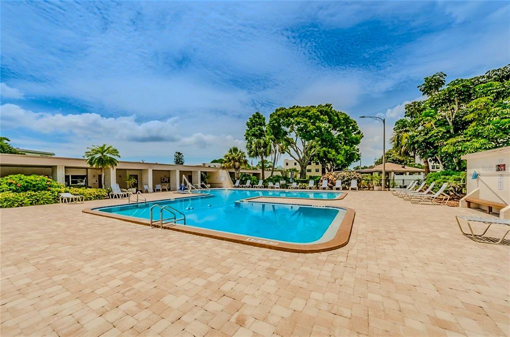 5660 80th Street North, Unit A303 St. Petersburg, FL 33709 - Photo 68 of 72 a view of a swimming pool with a yard