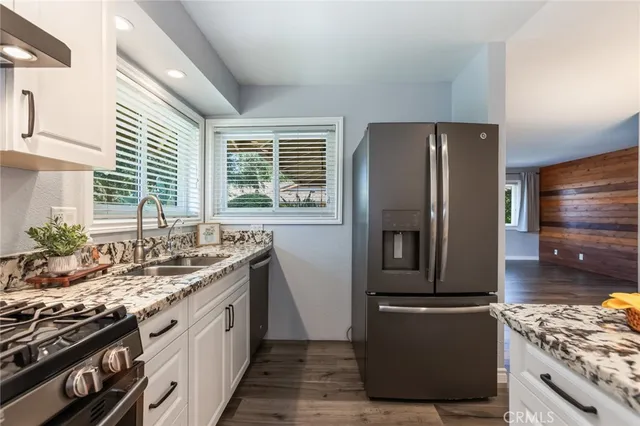 a view of a dining room with furniture wooden floor and a chandelier