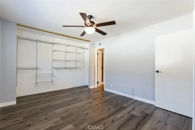 a view of a patio with table and chairs potted plants and palm trees