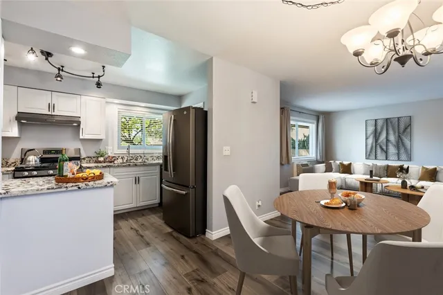 a kitchen with stainless steel appliances granite countertop a refrigerator and a stove top oven