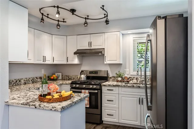 a bathroom with a granite countertop sink a toilet and shower