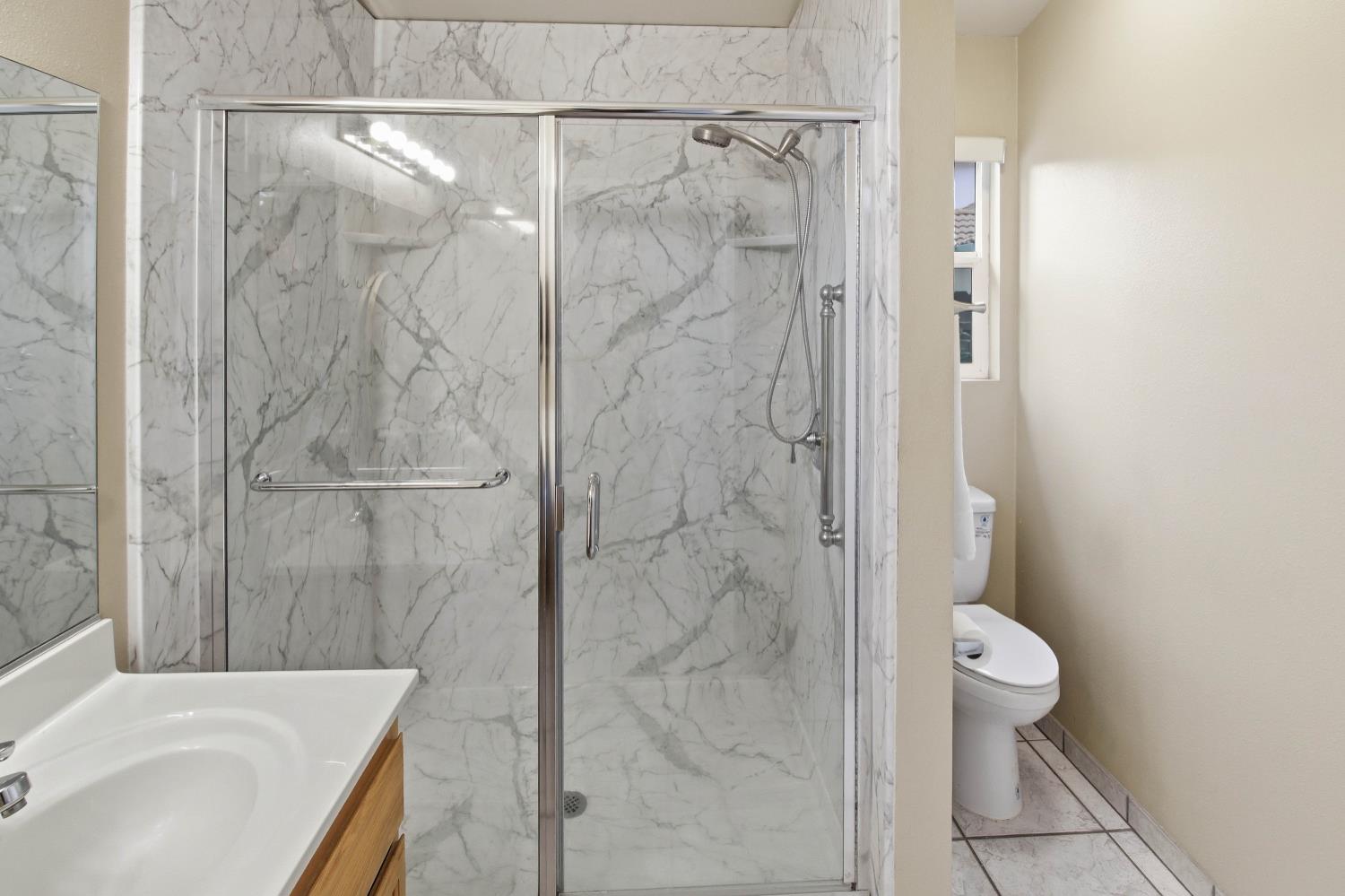 2128 Spy Glass Court Merced, CA 95340 - Photo 18 of 41 a bathroom with a sink and toilet