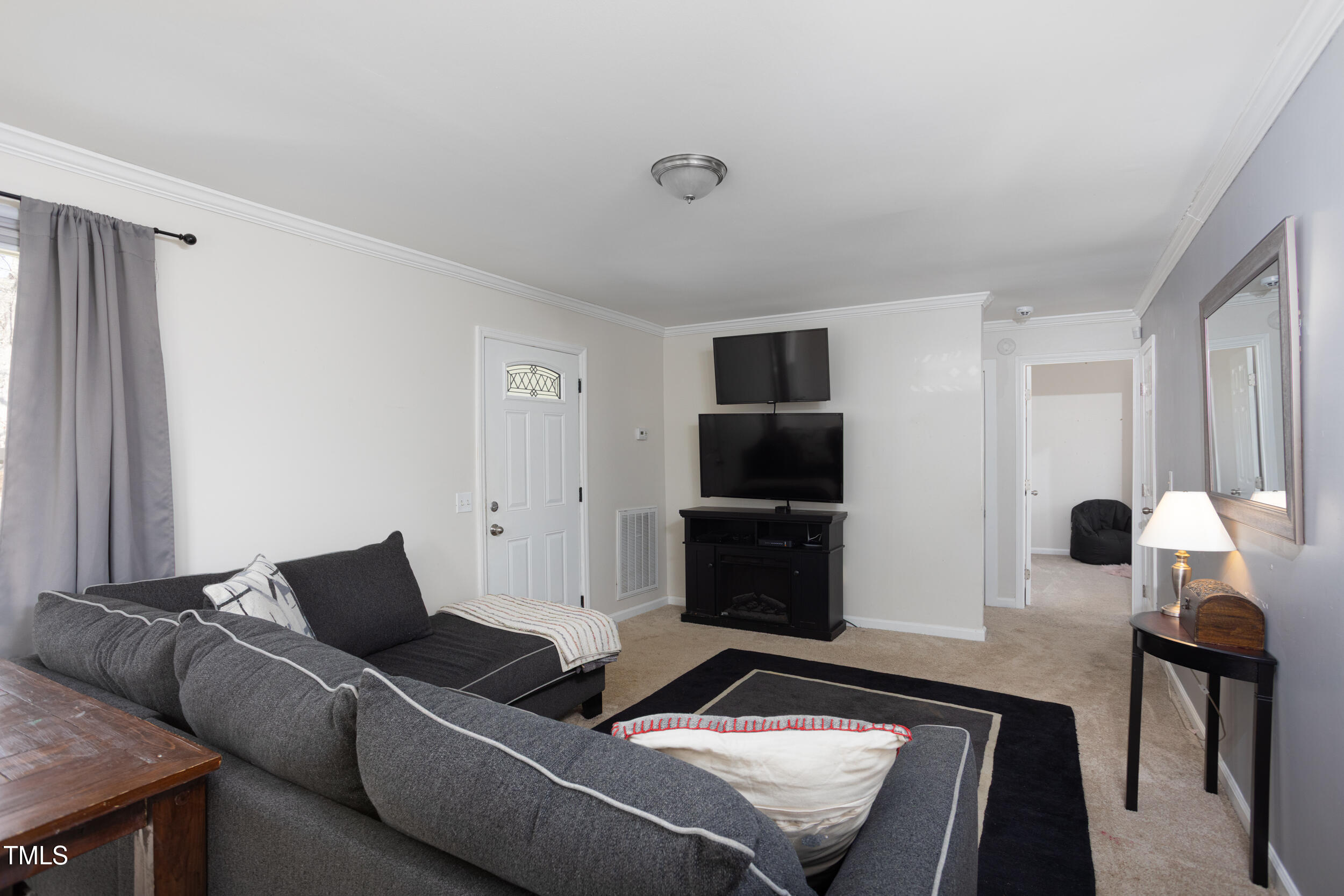 2701 Newbold Street Raleigh, NC 27603 - Photo 4 of 15 a living room with furniture and a flat screen tv