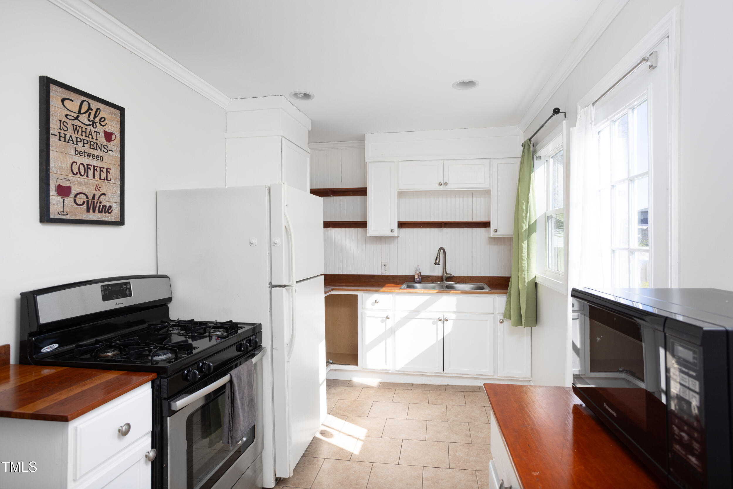 2701 Newbold Street Raleigh, NC 27603 - Photo 5 of 15 a kitchen with granite countertop a stove and a sink