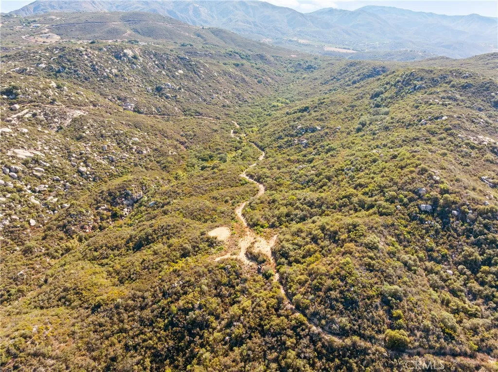 0 Pala Temecula Rd Valley Center Valley Center, CA 92082 - Photo 14 of 39 a view of a dry field with mountains in the background