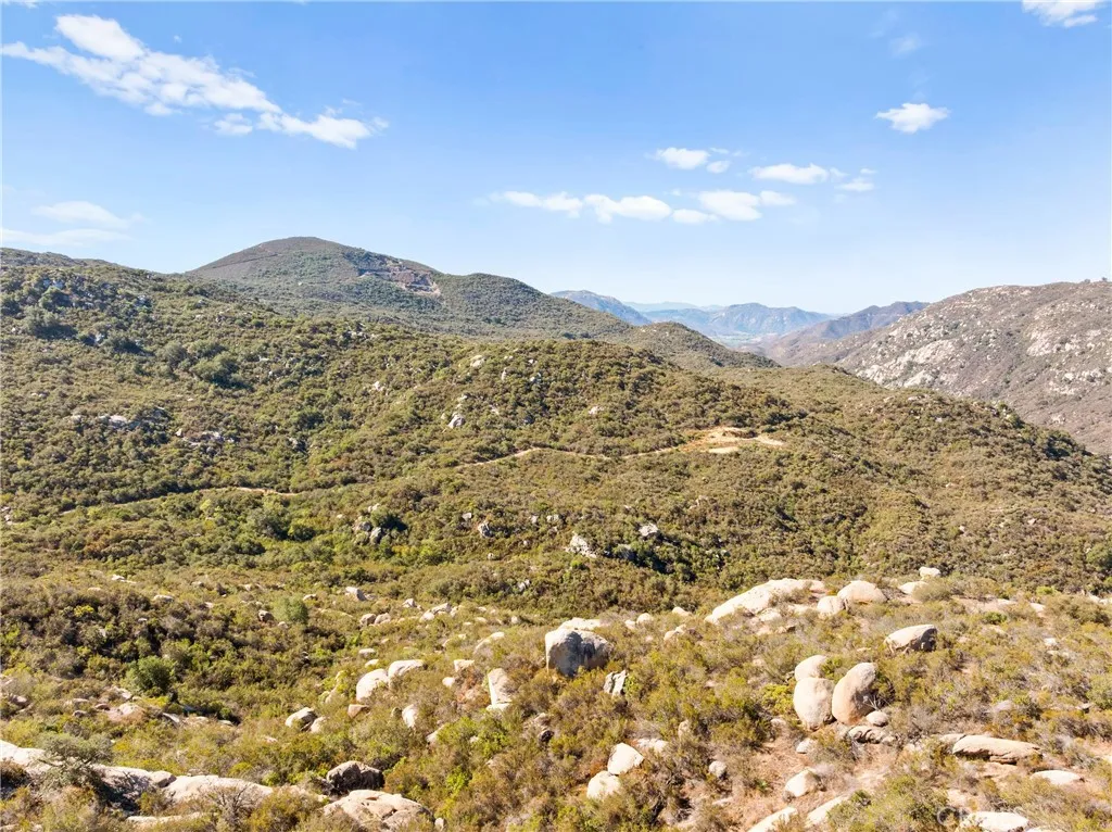 0 Pala Temecula Rd Valley Center Valley Center, CA 92082 - Photo 3 of 39 a view of a dry yard with mountains in the background