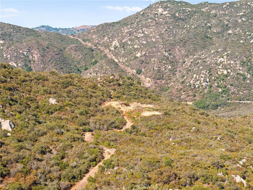 0 Pala Temecula Rd Valley Center Valley Center, CA 92082 - Photo 6 of 39 a view of a dry yard with mountains in the background