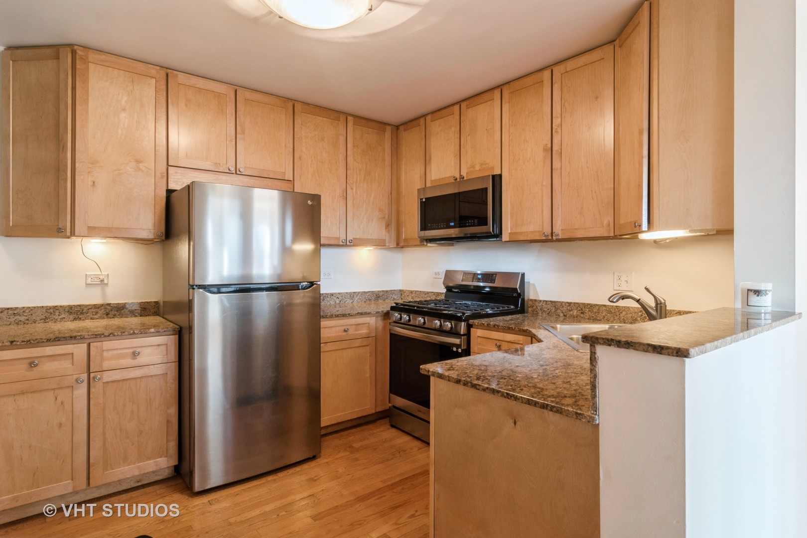 2901 West Arthur Avenue, Unit 3 Chicago, IL 60645 - Photo 5 of 13 a kitchen with a refrigerator stove and microwave