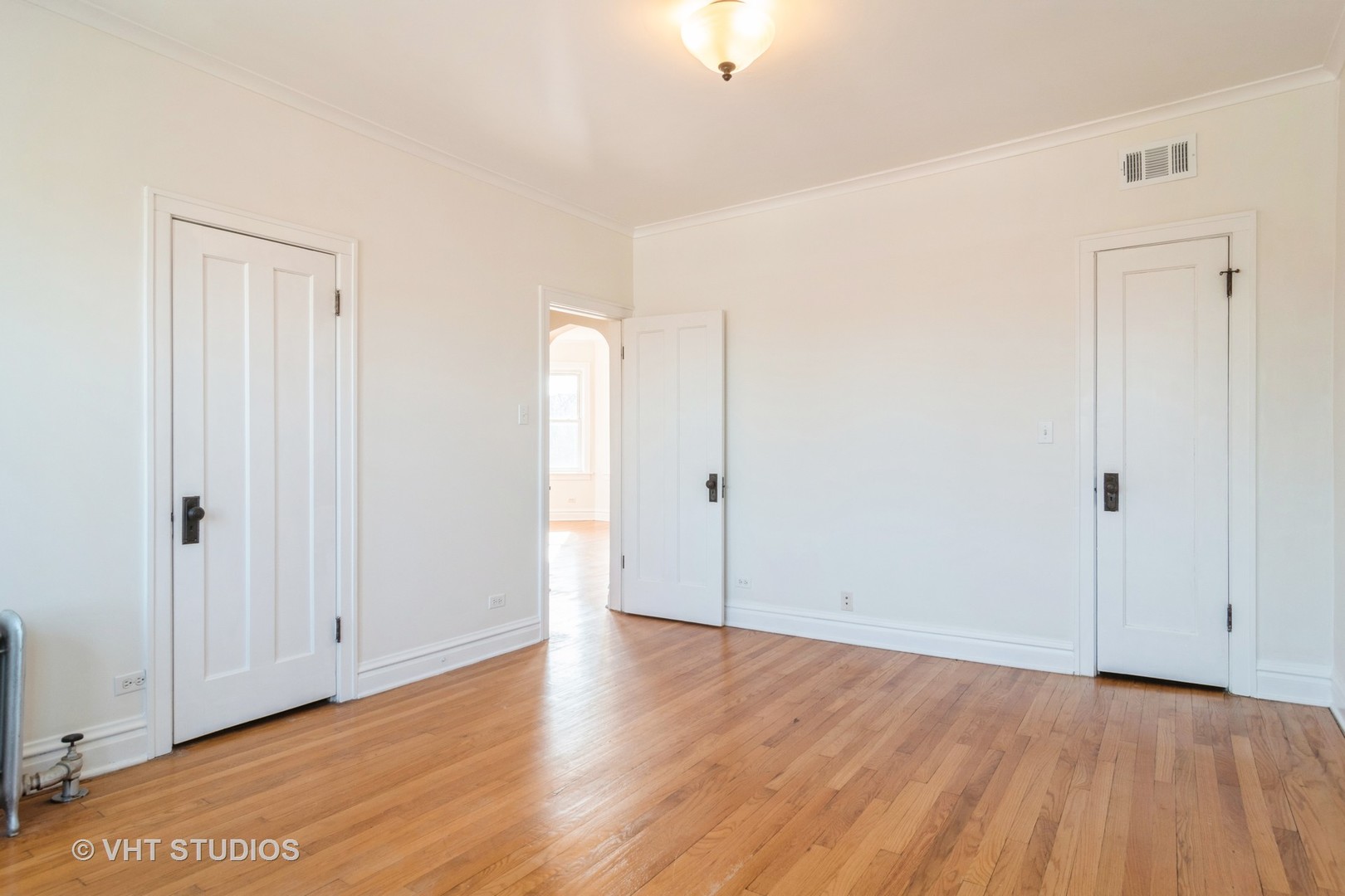 2901 West Arthur Avenue, Unit 3 Chicago, IL 60645 - Photo 7 of 13 an empty room with wooden floor