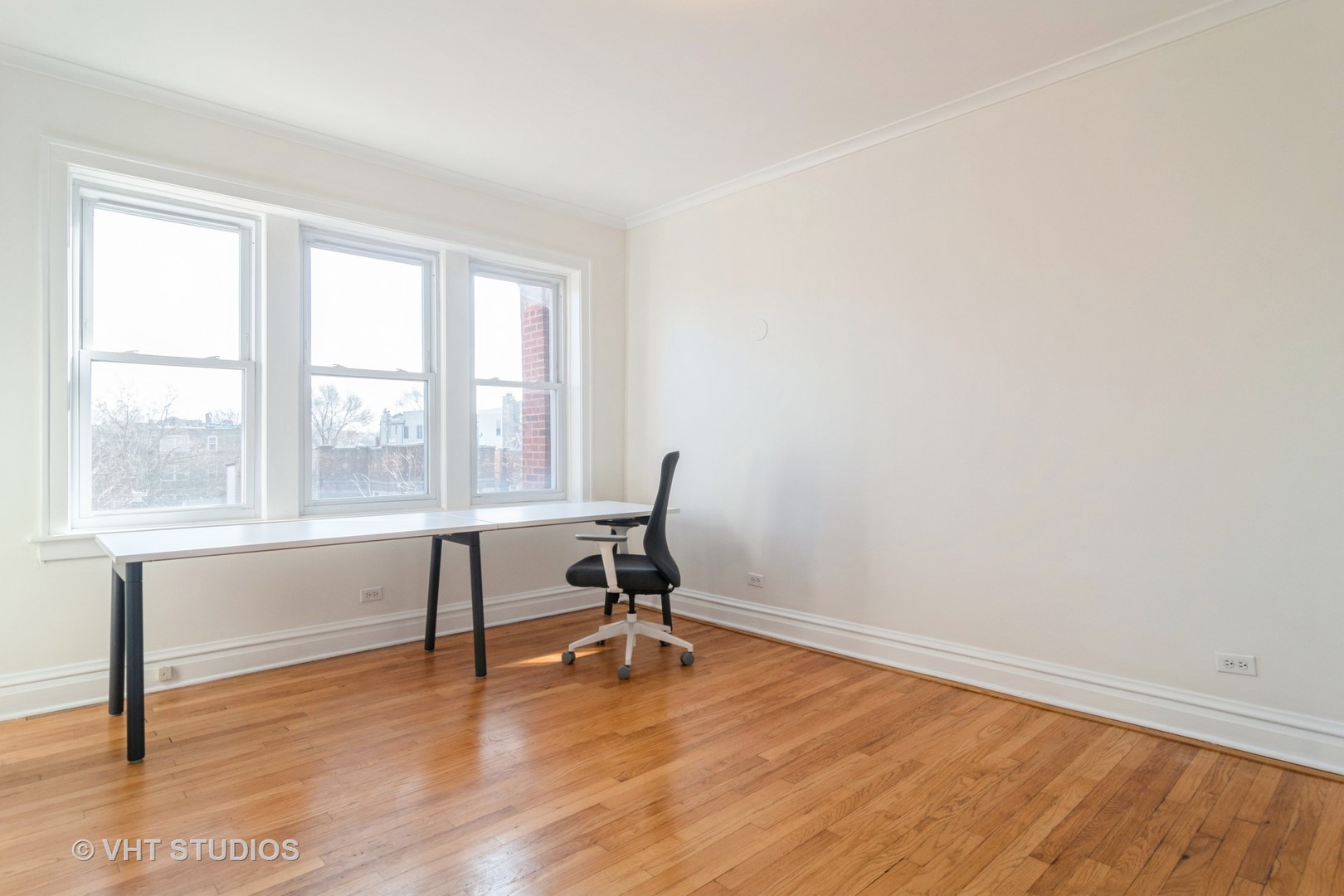 2901 West Arthur Avenue, Unit 3 Chicago, IL 60645 - Photo 8 of 13 a view of a workspace with wooden floor and a window