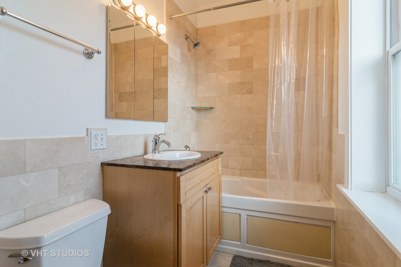 2901 West Arthur Avenue, Unit 3 Chicago, IL 60645 - Photo 10 of 13 a bathroom with a granite countertop sink a toilet and shower