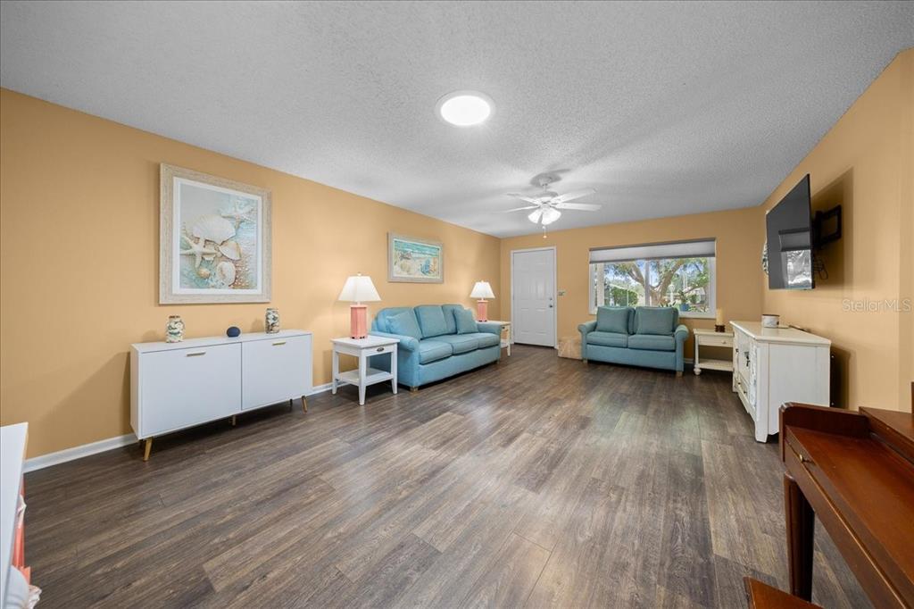 8720 Southwest 90th Street, Unit A Ocala, FL 34481 - Photo 14 of 71 a living room with furniture and a wooden floor