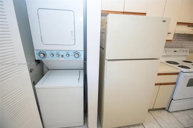 a kitchen with white cabinets and white appliances
