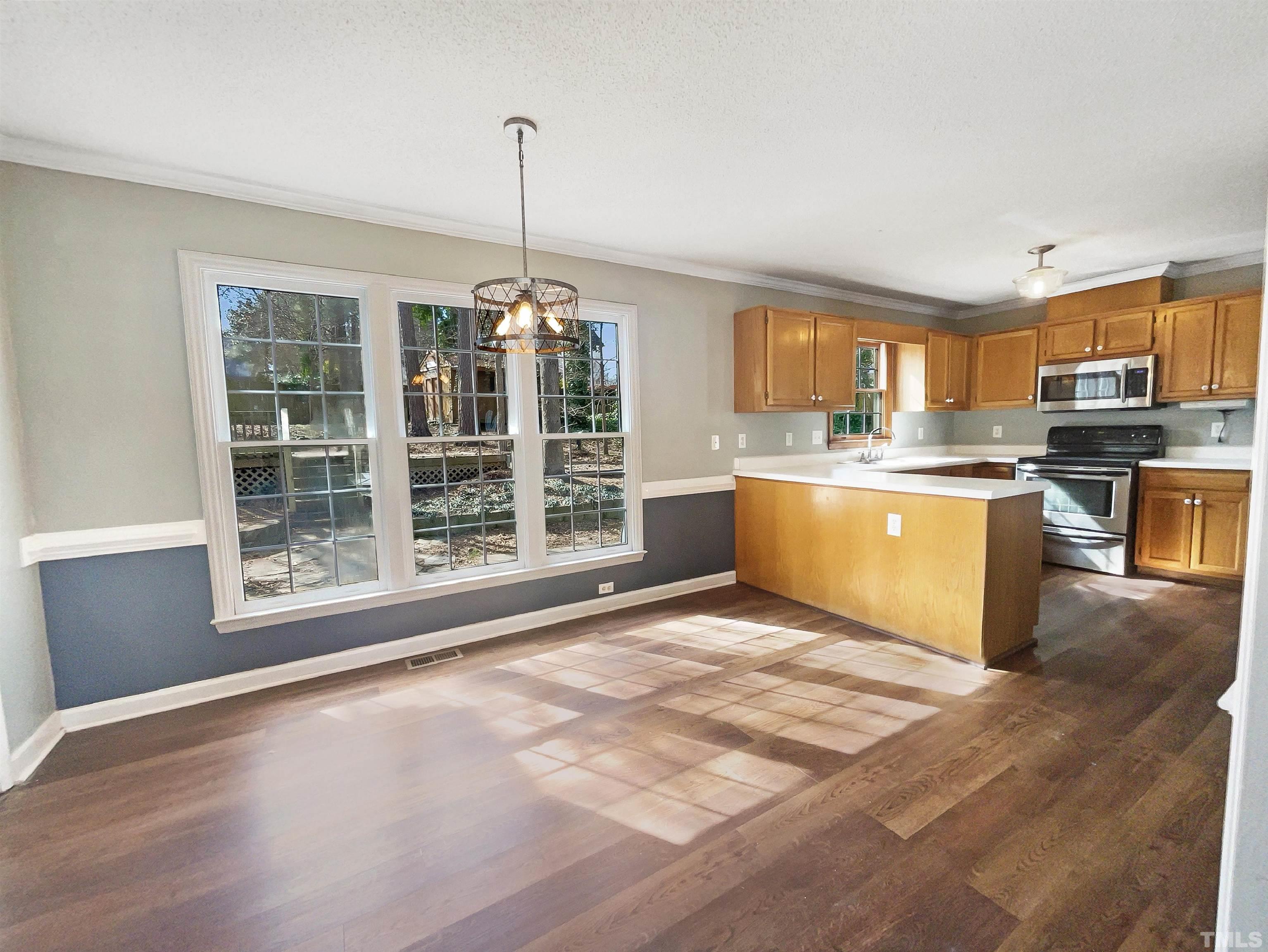 4320 Willow Lake Road Raleigh, NC 27616 - Photo 9 of 21 a view of a kitchen with a stove cabinets and a floor to ceiling window