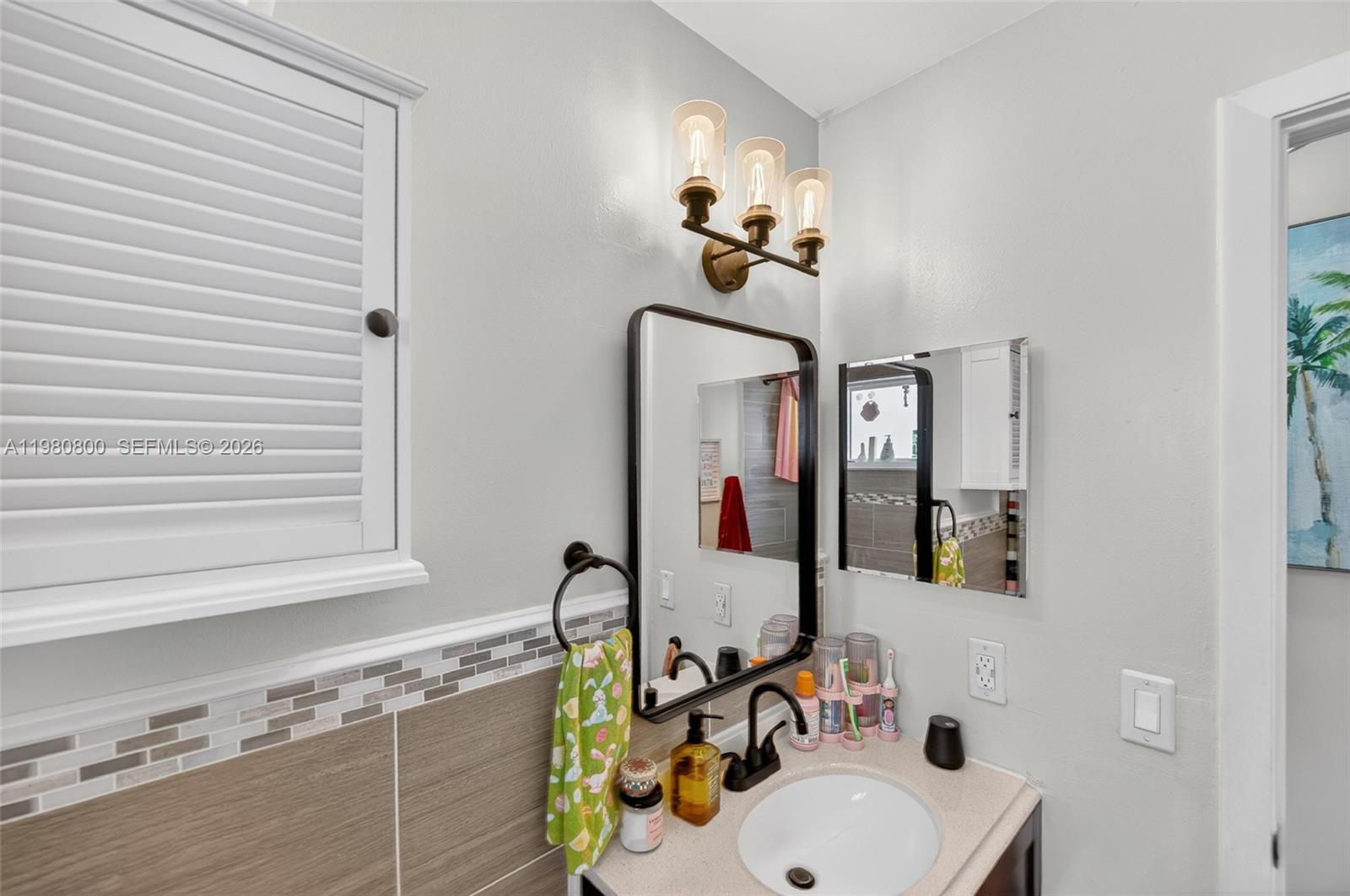 15260 Southwest 57th Street Miami, FL 33193 - Photo 14 of 22 a bathroom with a sink and a mirror