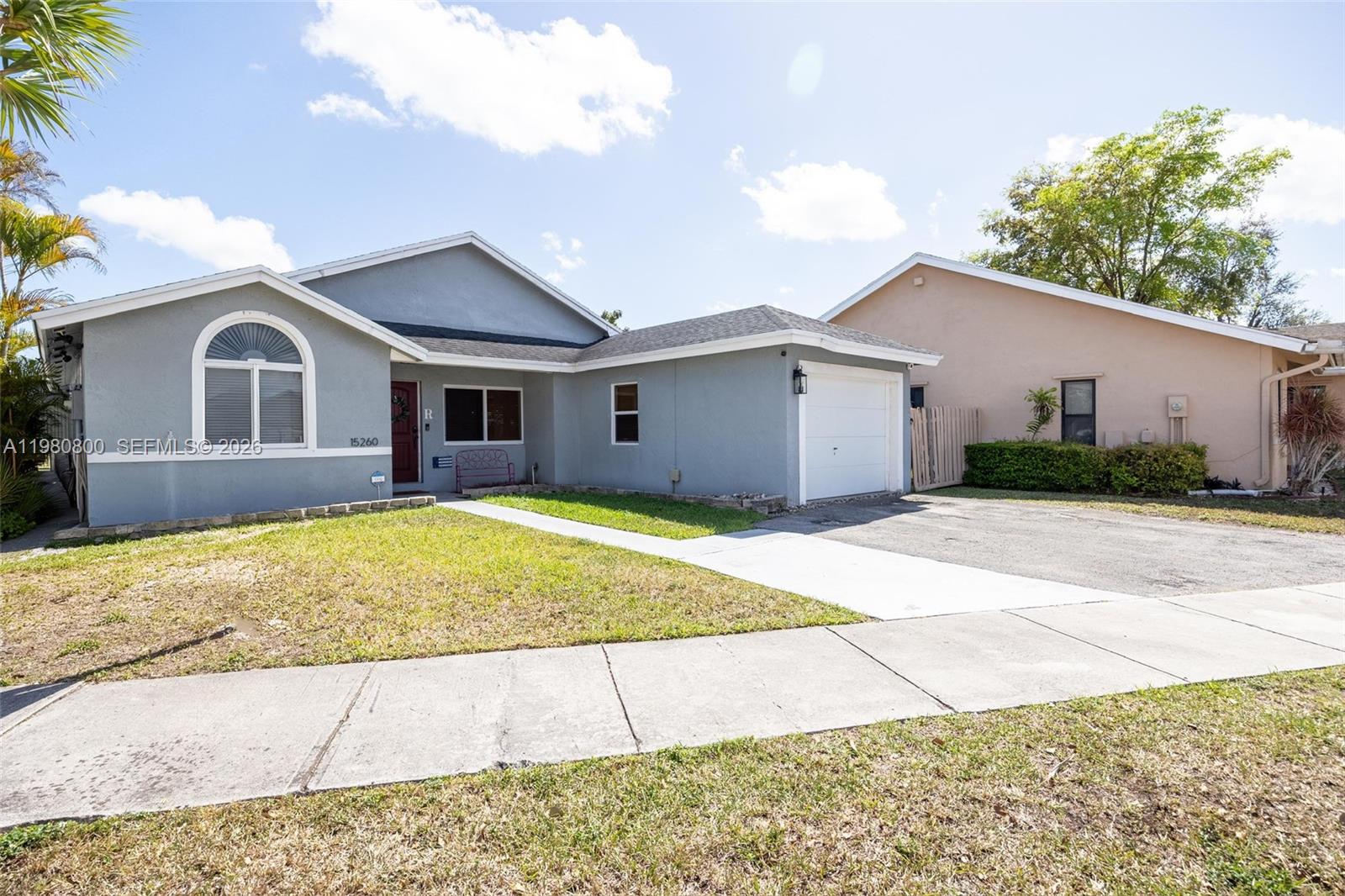 15260 Southwest 57th Street Miami, FL 33193 - Photo 2 of 22 a front view of a house with a yard and garage