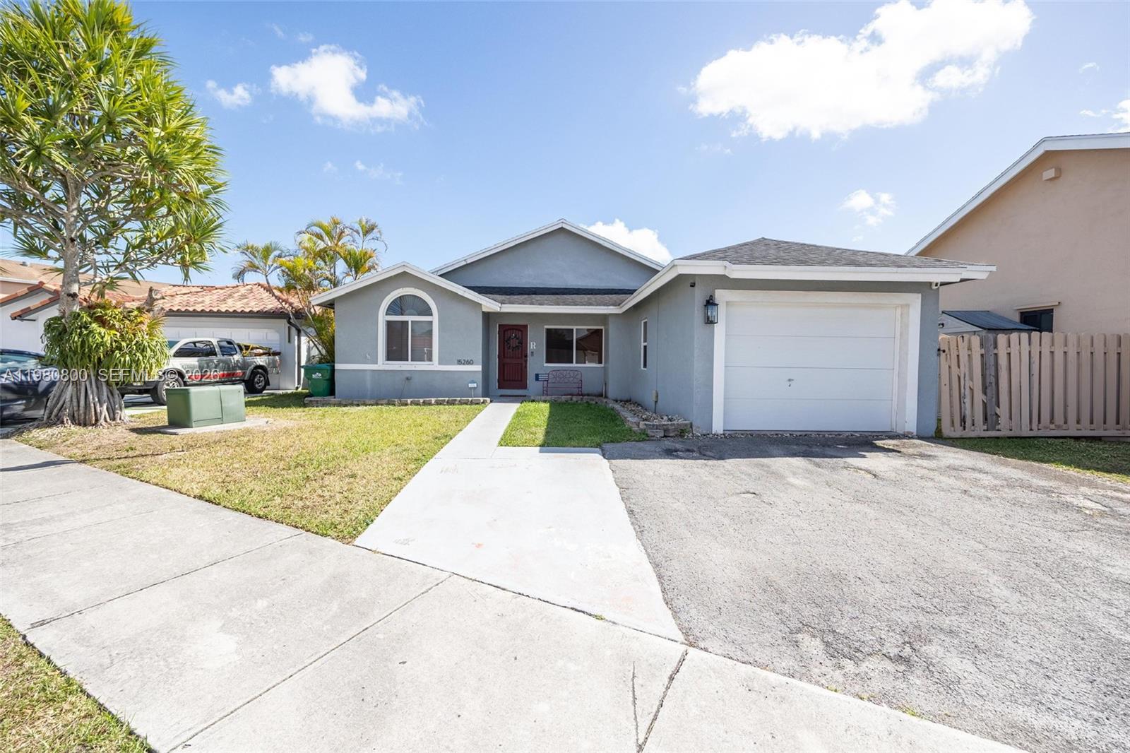 15260 Southwest 57th Street Miami, FL 33193 - Photo 3 of 22 a front view of a house with a yard and garage