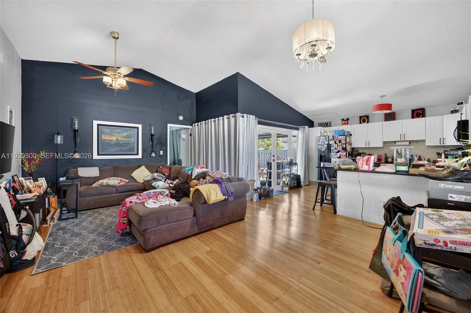 15260 Southwest 57th Street Miami, FL 33193 - Photo 7 of 22 a living room with furniture and a chandelier