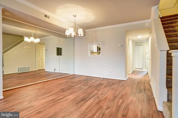 a view of empty room with wooden floor