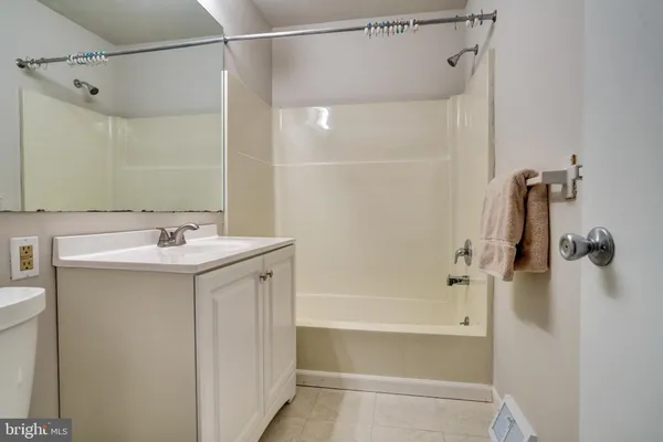 a bathroom with a shower sink and mirror
