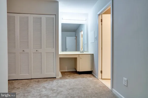 an entryway with a cabinet and a window