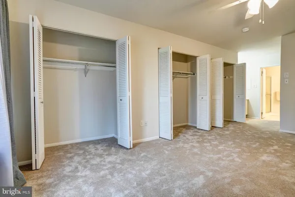 an empty room with closet and a bathroom