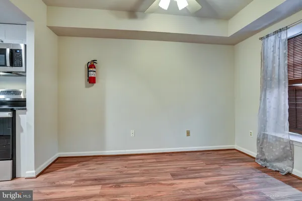a view of a room with wooden floor and window