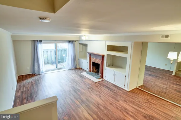 wooden floor in an empty room and a fireplace