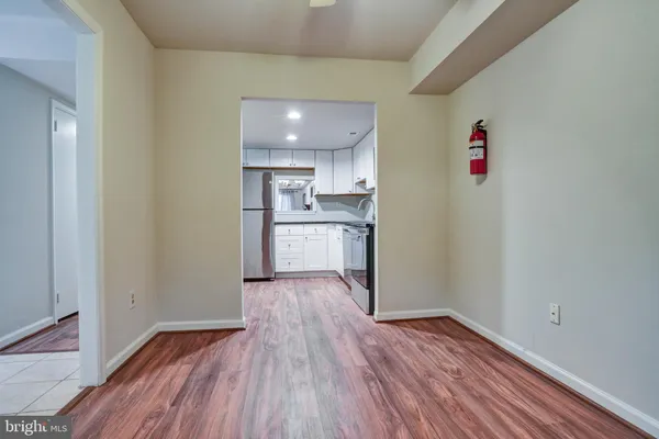 a view of a kitchen with wooden floor and a sink