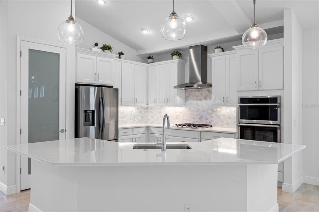12739 Rainwashed Loop Parrish, FL 34219 - Photo 13 of 45 a kitchen with counter top space cabinets and stainless steel appliances