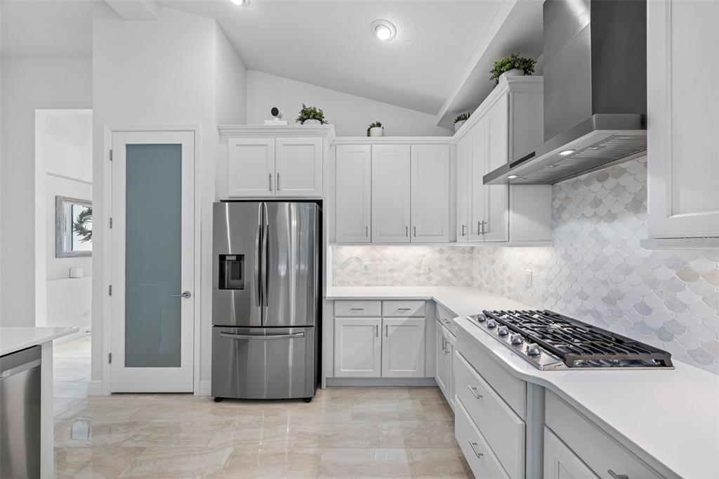12739 Rainwashed Loop Parrish, FL 34219 - Photo 15 of 45 a kitchen with stainless steel appliances granite countertop a refrigerator and a sink