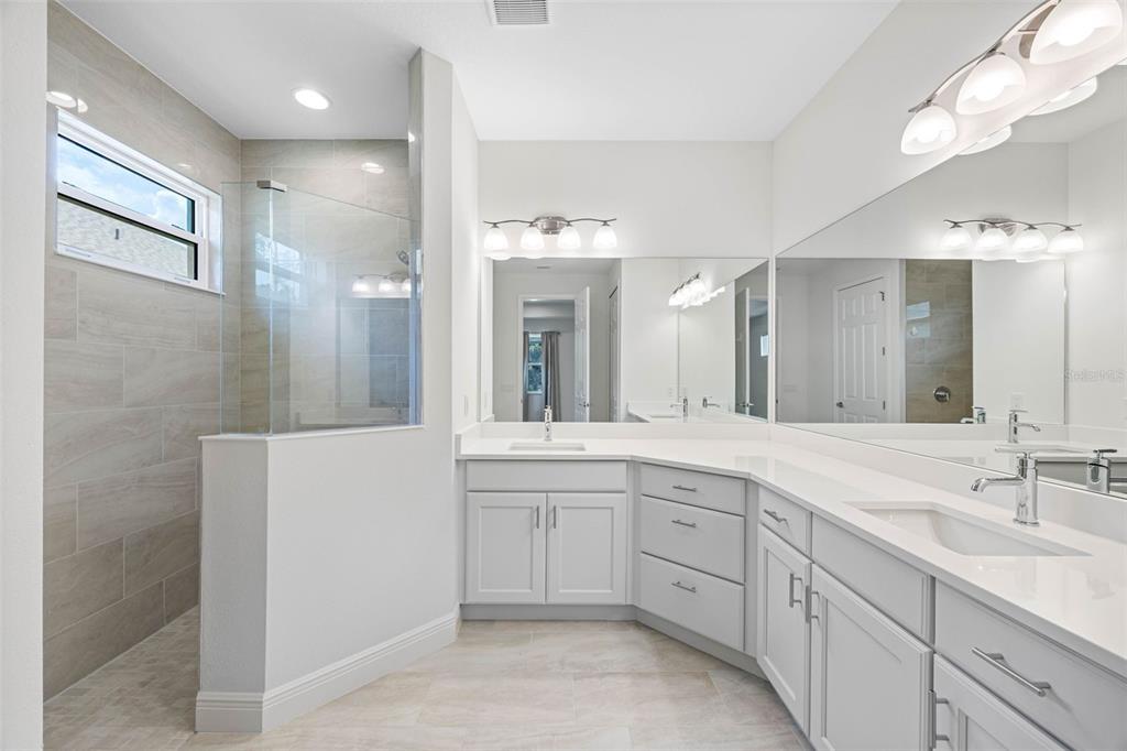 12739 Rainwashed Loop Parrish, FL 34219 - Photo 26 of 45 a spacious bathroom with a double vanity sink mirror and