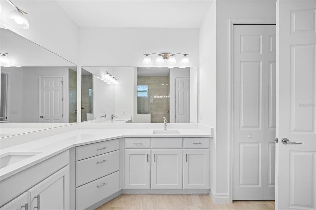 12739 Rainwashed Loop Parrish, FL 34219 - Photo 27 of 45 a spacious bathroom with a sink and a mirror