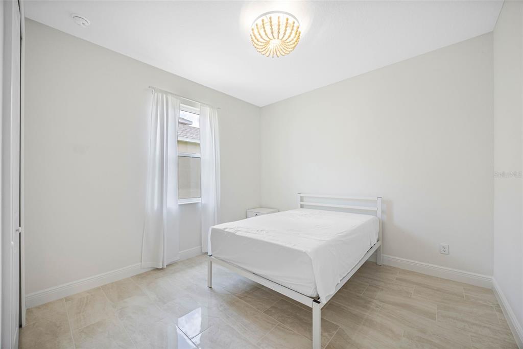 12739 Rainwashed Loop Parrish, FL 34219 - Photo 31 of 45 a bedroom with a bed and a window