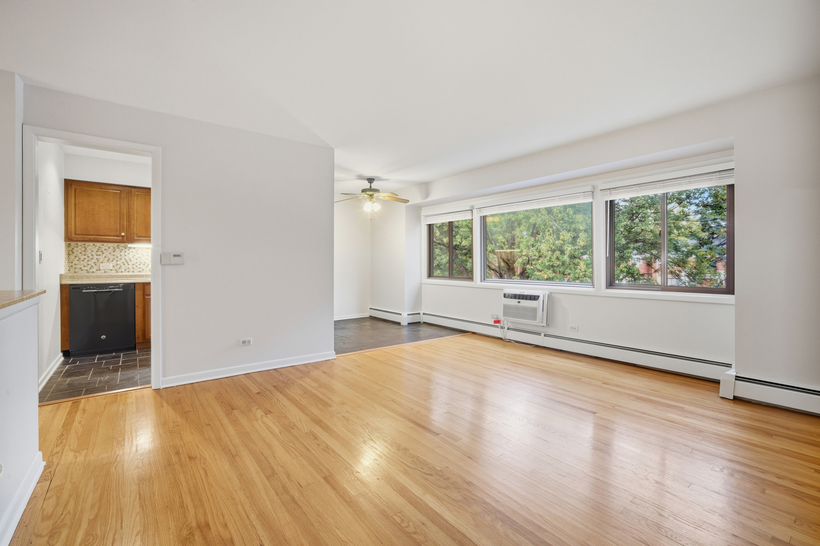 1341 Greenwillow Lane, Unit C Glenview, IL 60025 - Photo 12 of 28 a view of an empty room with wooden floor and a window