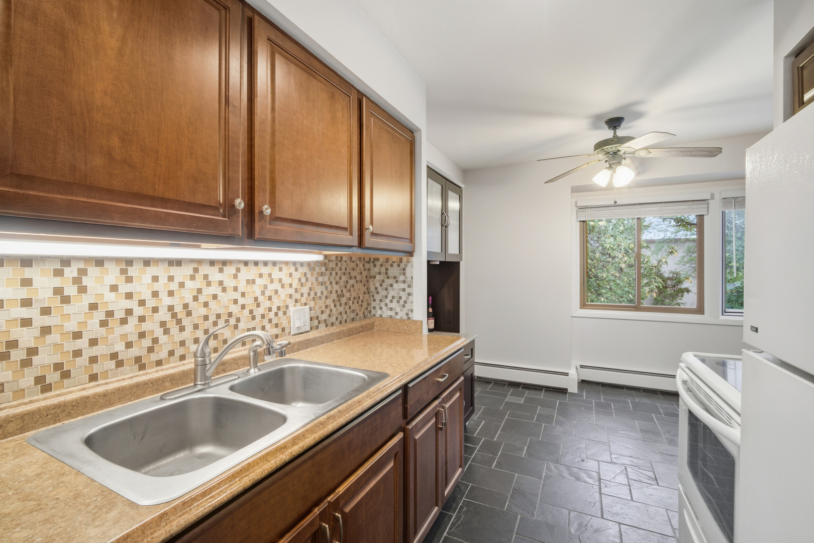 1341 Greenwillow Lane, Unit C Glenview, IL 60025 - Photo 14 of 28 a kitchen with a sink stove and microwave