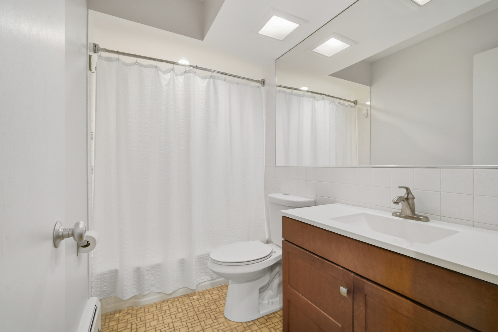 1341 Greenwillow Lane, Unit C Glenview, IL 60025 - Photo 20 of 28 a bathroom with a sink a toilet and shower