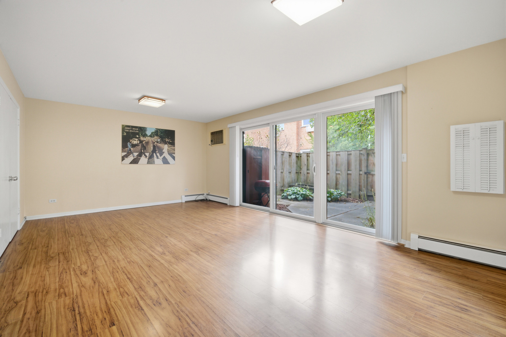 1341 Greenwillow Lane, Unit C Glenview, IL 60025 - Photo 6 of 28 a view of an empty room with wooden floor and a window