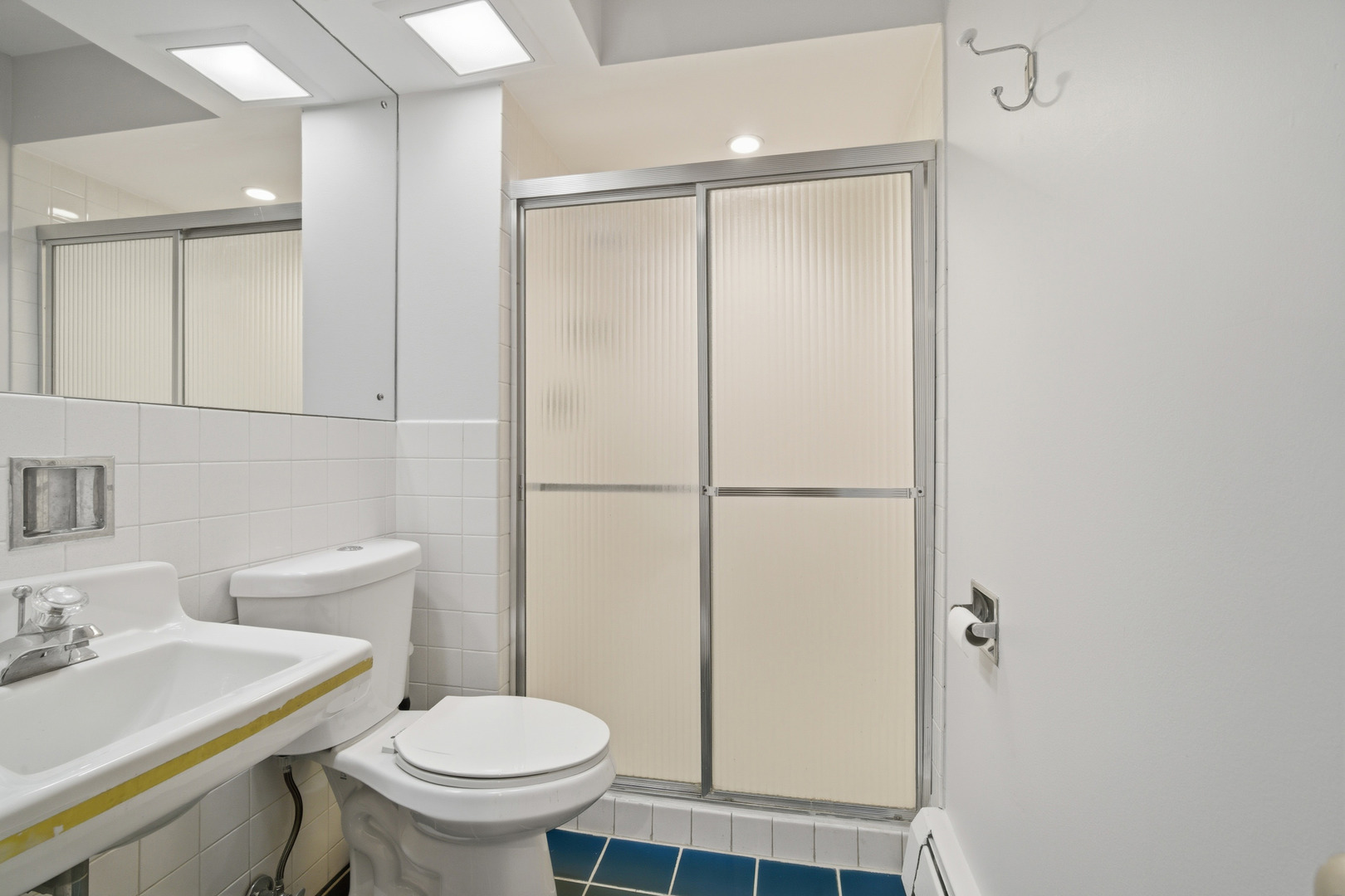 1341 Greenwillow Lane, Unit C Glenview, IL 60025 - Photo 7 of 28 a white toilet sitting next to a bathroom sink