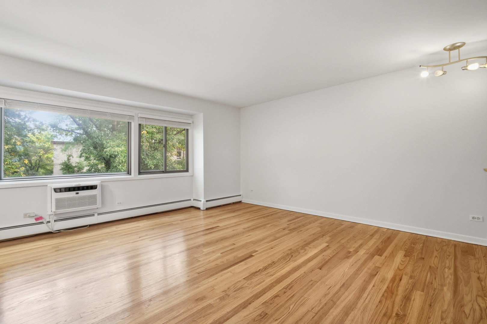1341 Greenwillow Lane, Unit C Glenview, IL 60025 - Photo 9 of 28 wooden floor in an empty room with a window