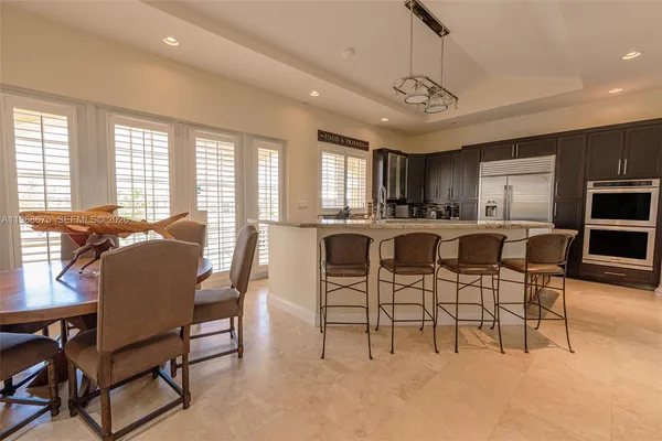 a kitchen with stainless steel appliances granite countertop a sink a stove and a microwave