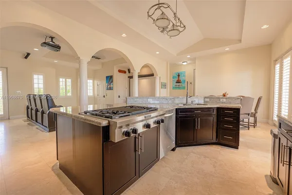 a kitchen with stainless steel appliances granite countertop a stove a sink and a refrigerator