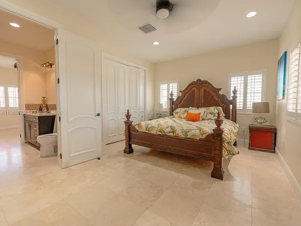 a bedroom with a bed and window