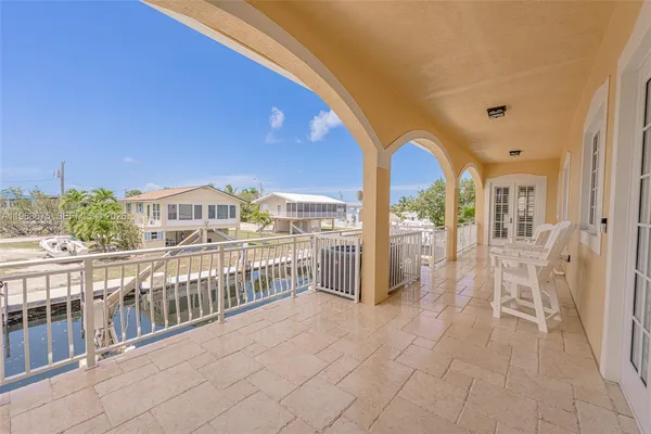 a view of a house with a backyard porch and sitting area