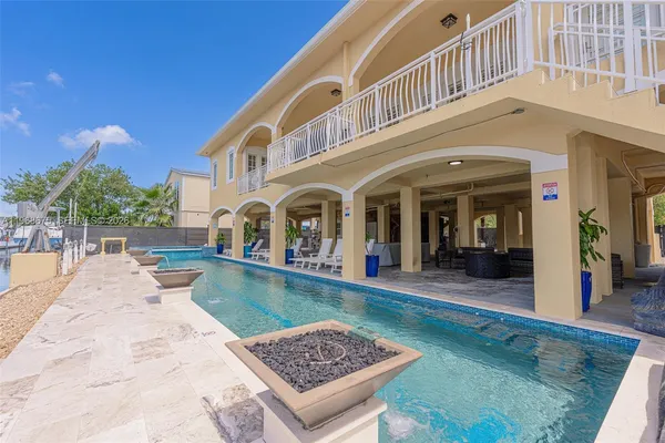 a view of a swimming pool with outdoor seating