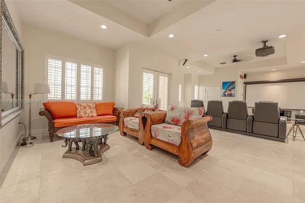 a living room with lots of furniture and a chandelier